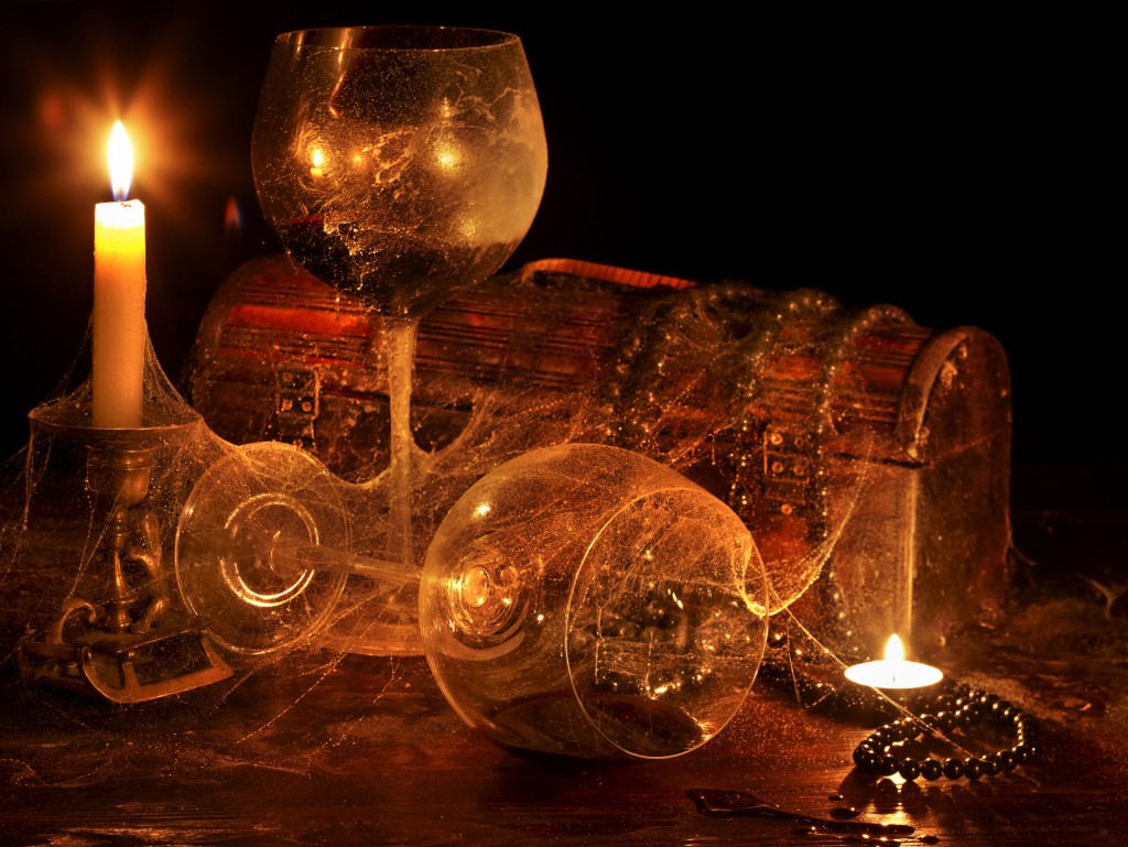 Two wine glass and candle on dark